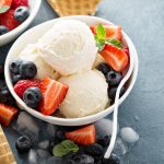 Vanilla ice cream scoops with fresh berries